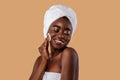 Portrait of happy black woman cleaning skin by cotton pad Royalty Free Stock Photo