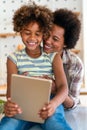 Portrait of happy black woman and her cute preteen daughter having fun together at home Royalty Free Stock Photo