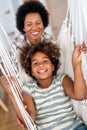 Portrait of happy black woman and her cute preteen daughter having fun together at home Royalty Free Stock Photo