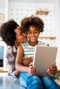 Portrait of happy black woman and her cute preteen daughter having fun together at home Royalty Free Stock Photo