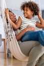 Portrait of happy black woman and her cute preteen daughter having fun together at home Royalty Free Stock Photo