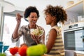 Portrait of happy black woman and her cute preteen daughter having fun together at home Royalty Free Stock Photo