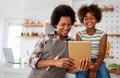 Portrait of happy black woman and her cute preteen daughter having fun together at home Royalty Free Stock Photo