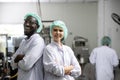 Portrait happy black worker laugh smiling together with woman friend standing arm crossed working in food and drink factory with