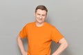 Portrait of happy blond mature man wearing orange T-shirt Royalty Free Stock Photo