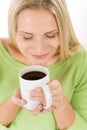 Portrait of happy blond woman enjoy coffee