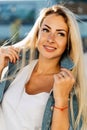 Portrait of happy blonde woman on blurred background in city Royalty Free Stock Photo