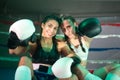 Portrait of happy boxer girls posing for camera on ring Royalty Free Stock Photo