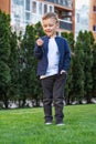 Portrait of happy boy. Child is smiling in spring day. Kid is enjoying spring. Sunny day. Boy holding dandelion. Outdoor Royalty Free Stock Photo