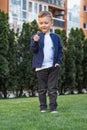 Portrait of happy boy. Child is smiling in spring day. Kid is enjoying spring. Sunny day. Boy holding dandelion. Outdoor Royalty Free Stock Photo