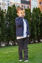 Portrait of happy boy. Child is smiling in spring day. Kid is enjoying spring. Sunny day. Boy holding dandelion. Outdoor Royalty Free Stock Photo