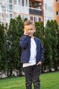 Portrait of happy boy. Child is smiling in spring day. Kid is enjoying spring. Sunny day. Boy holding dandelion. Outdoor Royalty Free Stock Photo