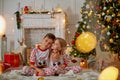 Portrait of happy boy laughing in his sister embrace on Christmas evening