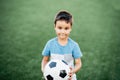 portrait of happy boy lying on football field. Royalty Free Stock Photo