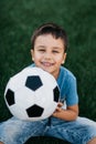 portrait of happy boy lying on football field. Royalty Free Stock Photo