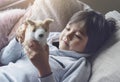 Portrait Happy boy lying on sofa playing with dog toy,  Healthy child boy  playing with his toy relaxing at home on weekend, Relax Royalty Free Stock Photo