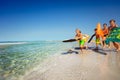 Boy running into sea leaping onto his body board Royalty Free Stock Photo