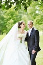 Portrait of happy bride and groom in a park Royalty Free Stock Photo