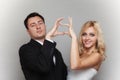 Portrait of happy bride and groom showing heart sign Royalty Free Stock Photo