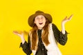 Portrait of a happy brown-haired girl makes a gesture with her fingers, shows an empty space with a surprised expression Royalty Free Stock Photo