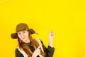 Portrait of a happy brown-haired girl makes a gesture with her fingers, shows an empty space with a surprised expression Royalty Free Stock Photo