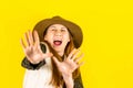 The portrait of a happy brown-haired woman makes a gesture with her fingers, with a surprised expression on her face Royalty Free Stock Photo