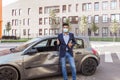 Portrait of happy brunette man wearing medical mask, jeans and jacket, holding tablet in hand and showing thumb up, insurance Royalty Free Stock Photo