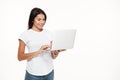 Portrait of a happy woman using laptop computer while standing Royalty Free Stock Photo