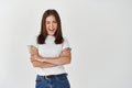 Portrait of happy brunette woman winking at you, smiling and looking coquettish, flirting while standing over white Royalty Free Stock Photo