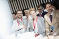 Portrait of happy business people sitting in seminar hall Royalty Free Stock Photo