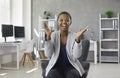 Portrait of happy business woman sitting on office chair, clapping hands and smiling Royalty Free Stock Photo