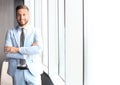 Portrait of happy businessman with arms crossed standing in office Royalty Free Stock Photo