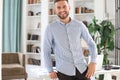 Portrait of happy businessman with arms crossed standing in office Royalty Free Stock Photo