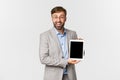 Portrait of happy businessman in gray suit and glasses, introduce application or diagram, showing digital tablet screen Royalty Free Stock Photo