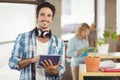 Portrait of happy businessman holding digital tablet creative office Royalty Free Stock Photo