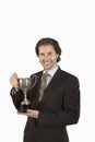 Portrait Of A Happy Businessman Holding Trophy Royalty Free Stock Photo