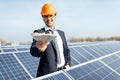 Businessman with money on a solar power plant