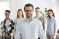 Portrait of happy businessman posing with team at background Royalty Free Stock Photo