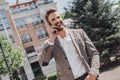 See things in the present, even if they are in the future. Handsome brown-haired modern businessman with beard walking Royalty Free Stock Photo