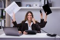 Businesswoman Doing Multitasking Work In Office