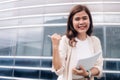 Portrait of happy businesswoman holding document and pen in the city Royalty Free Stock Photo