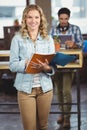 Portrait of happy businesswoman holding file in ofice Royalty Free Stock Photo