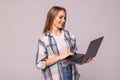 Portrait of a happy businesswoman holding laptop computer iand looking away solated over white background Royalty Free Stock Photo