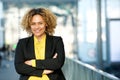 Happy businesswoman posing with arms crossed