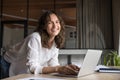 Portrait of happy businesswoman posing for camera, working on laptop Royalty Free Stock Photo