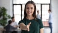 Portrait of happy businesswoman stretch hand welcoming newcomer