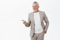 Portrait of happy calm and confident charismatic old granddad in formal elegant suit holding hand in pocket looking and Royalty Free Stock Photo