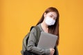 Portrait of happy casual Asian girl student wearing face mask to study with backpack and laptop back to school and learning Royalty Free Stock Photo