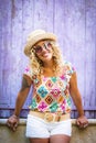 Portrait of happy casual colorful clothes middle age young woman smiling at the camera standing against a purple wood background Royalty Free Stock Photo