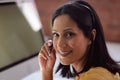 Portrait of happy caucasian businesswoman wearing phone headset sitting at desk turning and smiling Royalty Free Stock Photo